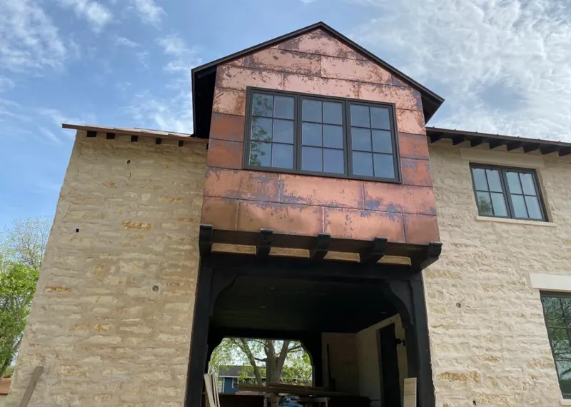 Copper metal panel facade on a stone building for Skylight Installation in Menasha